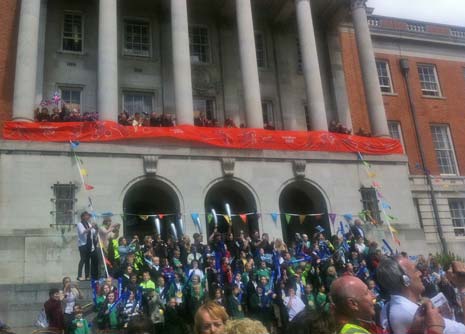 The Town Hall filled with cheering spectators, on the balcony and the steps