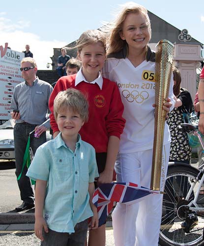 Molly Mee waits for the flame with friends Daniel and Jennifer Pare. Picture courtesy of Ian Pare