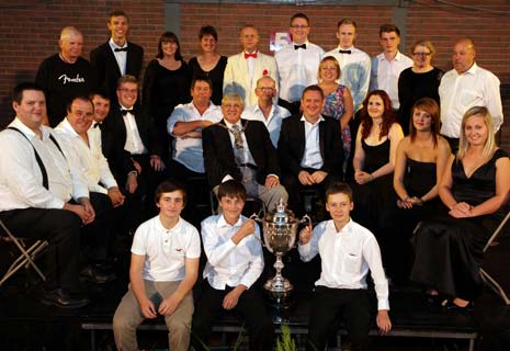 Members of Dronfield Band celebrating after being crowned as the 2012 winners, alongside Cllr Ken Savidge, Council Chair