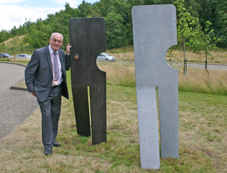 Chesterfield Borough Council Leader Cllr John Burrows with the first two pieces of the 'Walking Together' installation unveiled today