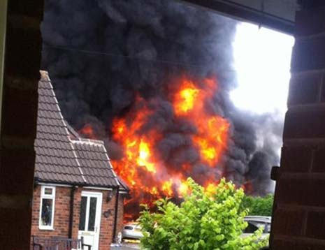 The initial explosion rips through a neighbouring house's double garage...