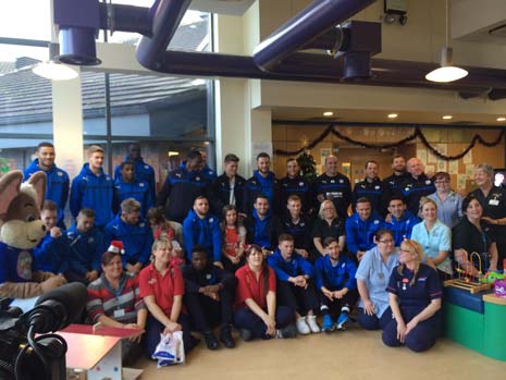 Chesterfield Manager Paul Cook and his players brought an early Christmas surprise to young patients in the Nightingale Ward of the Chesterfield Royal Hospital at Calow yesterday.