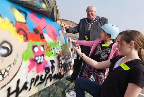 The Chair of North East Derbyshire District Council, Cllr Ken Savidge, tries his hand at graffiti art at Rykneld Homes Family Fun Day held at the Proact Stadium