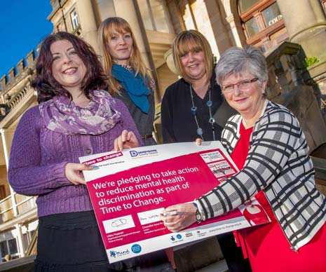Council Leader Councillor Anne Western (right) signs the Time to Change pledge with (from left) Councillor Ellie Wilcox, Deputy Cabinet Member for Health and Communities, Libby Peppiatt from Time to Change and Mags Young, Assistant Chief Executive of Derbyshire County Council.