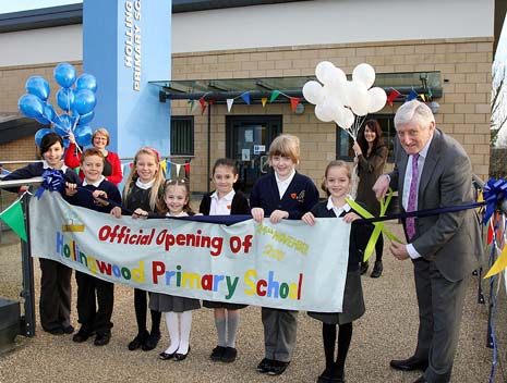 Councillor Mike Longden, Derbyshire County Council's Cabinet Member for Education, cuts the ribbon watched by pupils Freya Blackwell, William Aldred, both 10, Bethany Wood, nine, Melissa Clark, seven, Jasmin Blackwell, eight, Kimberley Guy, nine and Maisie Prigent, eight.