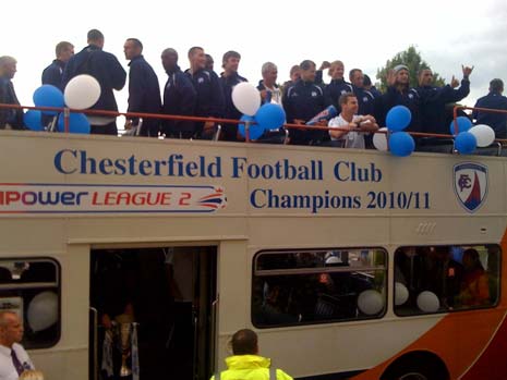 The team's open top bus arrives at the Town Hall
