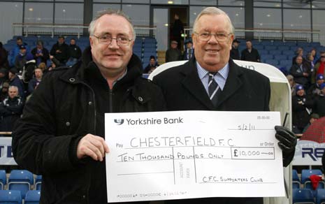 £10,000 cheque is presented to Chesterfield FC Chairman Barrie Hubbard by Mick Umney from the Supporters Club