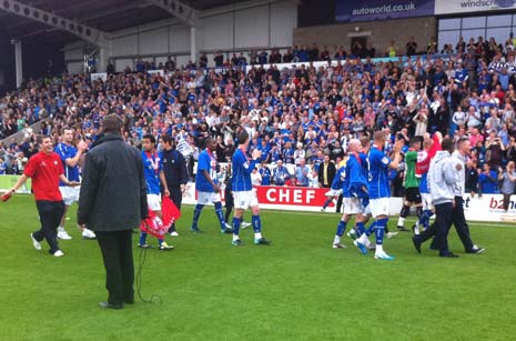 Players on the pitch wave to the fans
