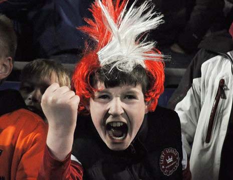 A young Ilkeston fan celebrates their Cup win