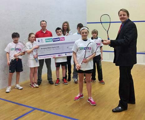 Chesterfield MP Toby Perkins (right) samples Brampton Manor's Squash facilities along with staff and young squash players and the Sport England funding cheque. 