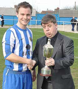 NCEL Chairman David Morrall presents the NCEL Division 1 championship trophy to Staveley MWFC Captain, Micheal Staley